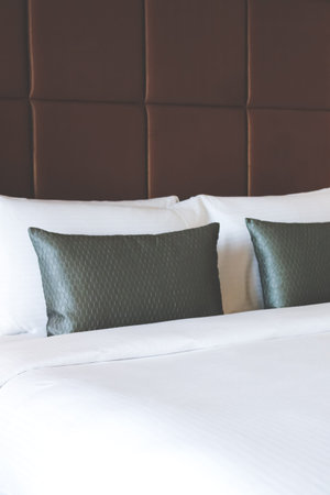 White pillows and grey pillows on bed in the luxury hotel.