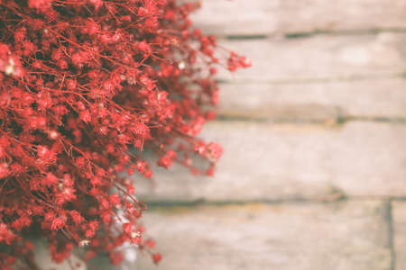 Red bouquet on wooden background.の写真素材