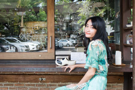 Beautiful Asian woman smiling in outdoor scene.の写真素材