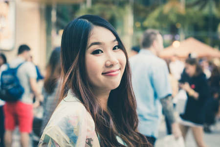 Beautiful Asian woman smiling with outdoor scene.の写真素材