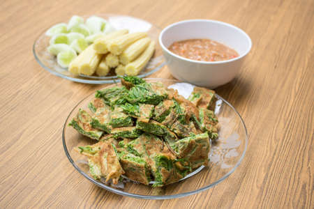 Thai food, Acacia Pennata Omelette and Shrimp-paste sauce, vegetables on wooden table backgroundの写真素材