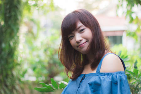 Close up of young pretty Asian woman in the gardenの写真素材