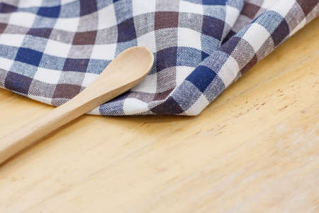 Kitchen napkin and spoon on wooden backgroundの写真素材