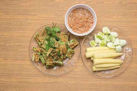 Top view of Acacia Pennata Omelette and Shrimp-paste sauce, vegetables on wooden background.の写真素材