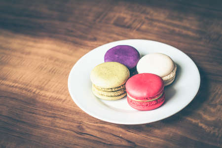 Colorful French Macarons on wooden background.の写真素材