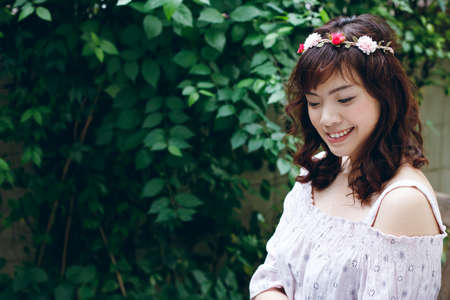 Young pretty Asian woman with flower headband.の写真素材