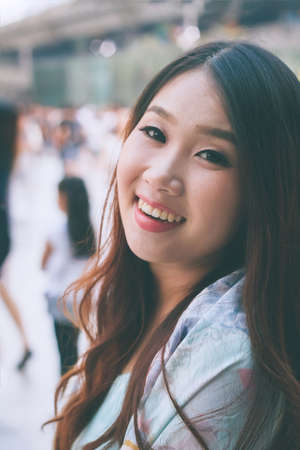 Beautiful Asian woman smiling with outdoor scene.の写真素材