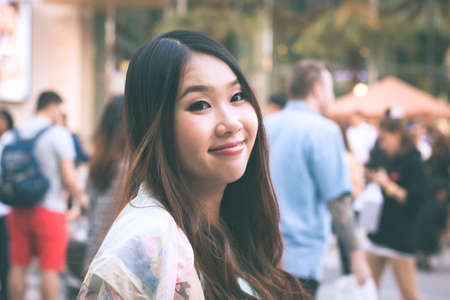 Beautiful Asian woman smiling with outdoor scene.の写真素材