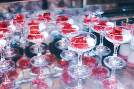 Red jelly with whipped cream in the restaurant.の写真素材