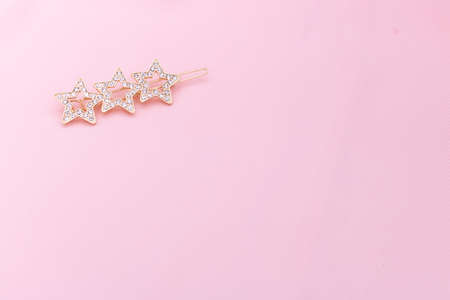 Luxury hair clip on pink fabric with copyspace.の写真素材