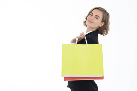 Portrait of young business woman holding shopping bags on white isolated background.の写真素材