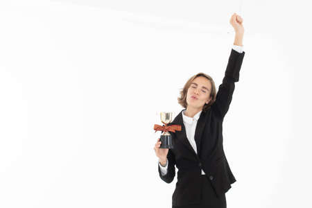 Portrait of successful business woman hoding trophy on white isolated background.の写真素材