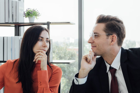 Two business people discussing about work in an office.