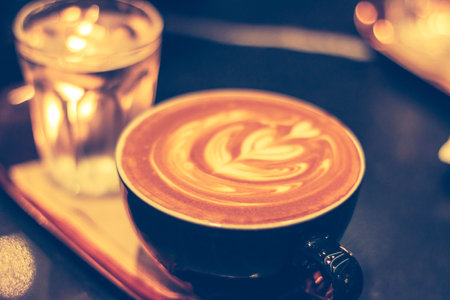 Close up of hot latte coffee in the cafe with blurred background.の写真素材