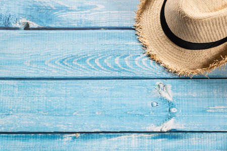 A straw hat on light blue wooden background, beach and Summer concept.の写真素材