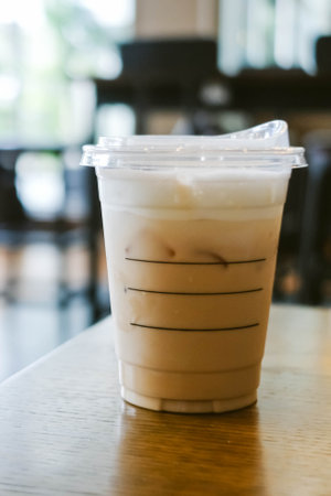 Iced caffe latte in the coffee shop with blur background.の写真素材