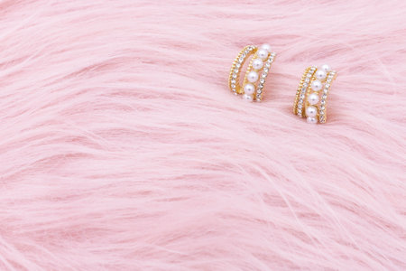 Earrings jewelry, Close up of a pair of luxury earrings on a pink background. Elegant earrings for women.の写真素材