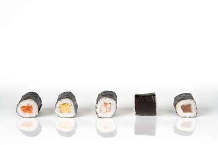 Top view of man taking photo of sushi on the white table. Social networking and take-away conceptの写真素材