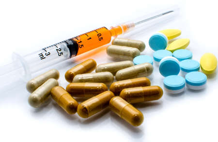 Macro of a Syringe and Pills on a white background の写真素材