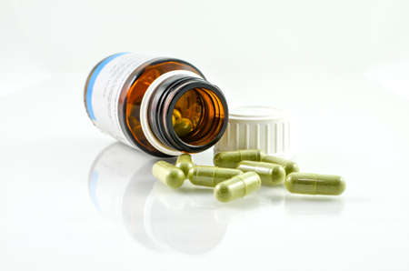 Spilled capsules from orange prescription bottle  High-quality 3d render の写真素材