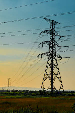 High voltage power pylons at sunset, Thailandの写真素材