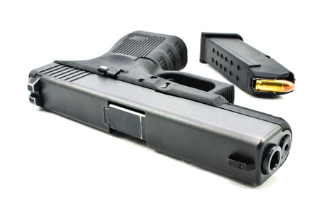 black handguns and  magazine on white background
