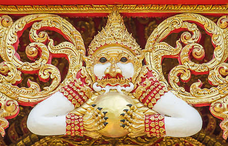 Hanuman statue sculpture on the roof of a temple in Thailand の写真素材