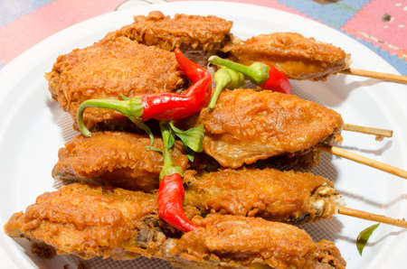 Chicken coated with spicy batter, fried and served in a hot plate.の写真素材