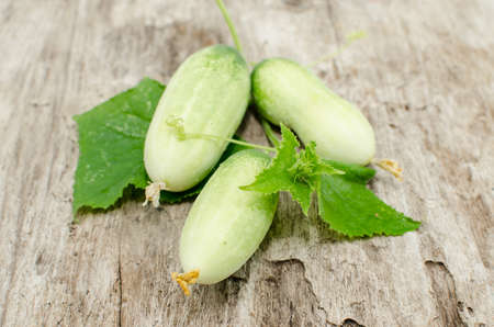 Fresh from the garden cucumbers on the wooden floor.の写真素材