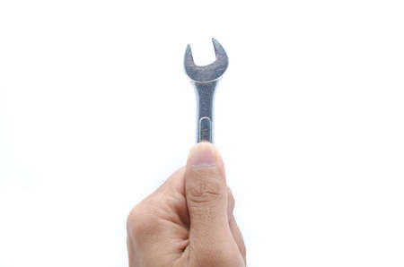 Hand with a new wrench isolated on whiteの写真素材