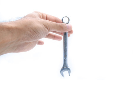 Hand with a new wrench isolated on white