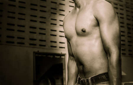 Young guy with muscular body with barbell over, dramaticの写真素材