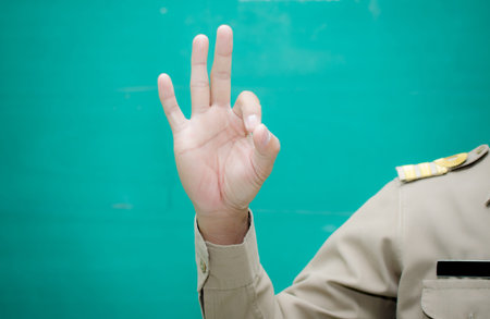 man hand show the number three on green background の写真素材