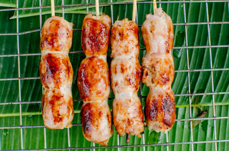 Bratwurst or Hot Dogs on Grill with Flamesの写真素材
