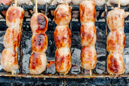 Bratwurst or Hot Dogs on Grill with Flamesの写真素材