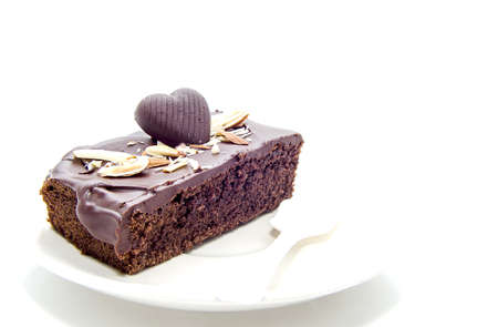 A heart shaped piece of chocolate isolated on whiteの写真素材