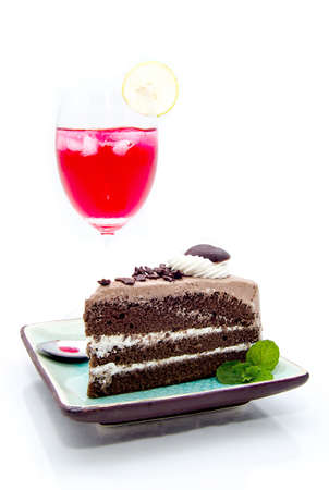 piece of chocolate cake and cocktail on white backgroundの写真素材