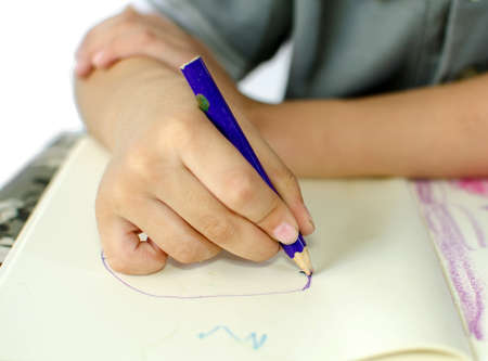 Cute little schoolboy drawing isolate on white backgroundの写真素材