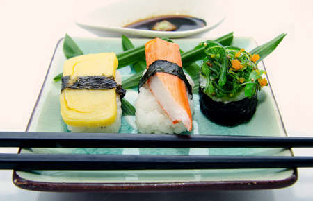 Different types of sushi in the plate isolated on white backgroundの写真素材