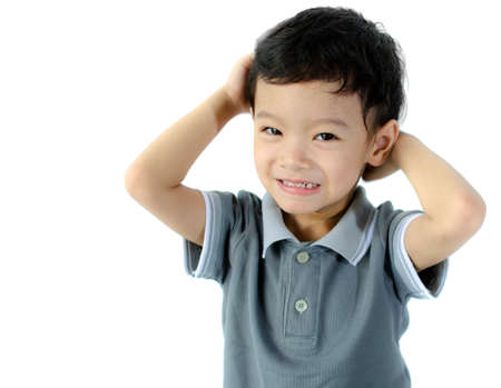 Confused child scratching his head isolated on a white backgroundの写真素材