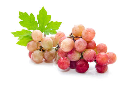 Grape cluster with leaves isolated on a white backgroundの写真素材