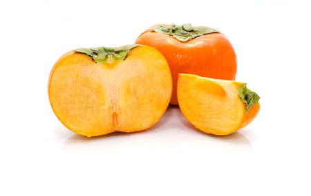 Ripe persimmon with cut isolated on white backgroundの写真素材