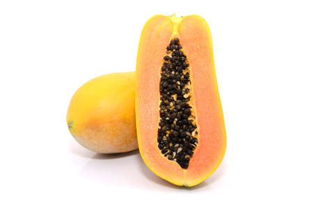 Half cut and whole papaya fruits on white background の写真素材