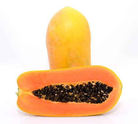 Half cut and whole papaya fruits on white backgroundの写真素材