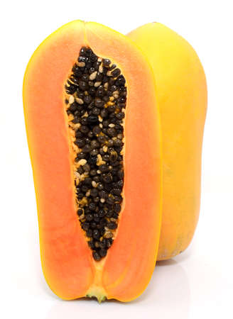 Half cut and whole papaya fruits on white backgroundの写真素材