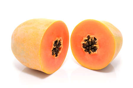 Half cut and whole papaya fruits on white backgroundの写真素材