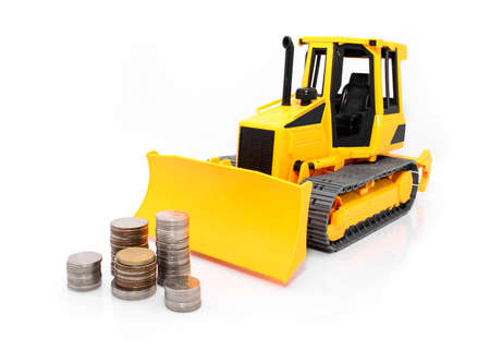 Yellow  tractor and coins isolated over white の写真素材