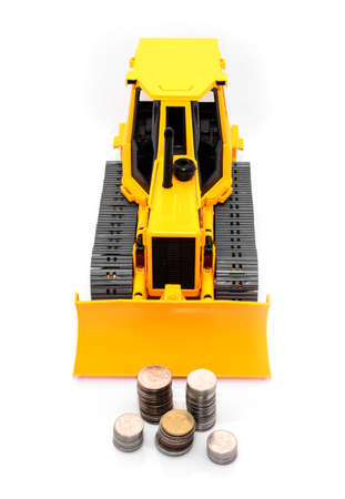 Yellow  tractor and coins isolated over white の写真素材