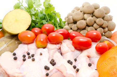 A whole chicken and soup vegetables for a chicken stockの写真素材