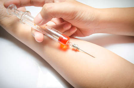 Hand with heroin syringe. Close-up photo.の写真素材